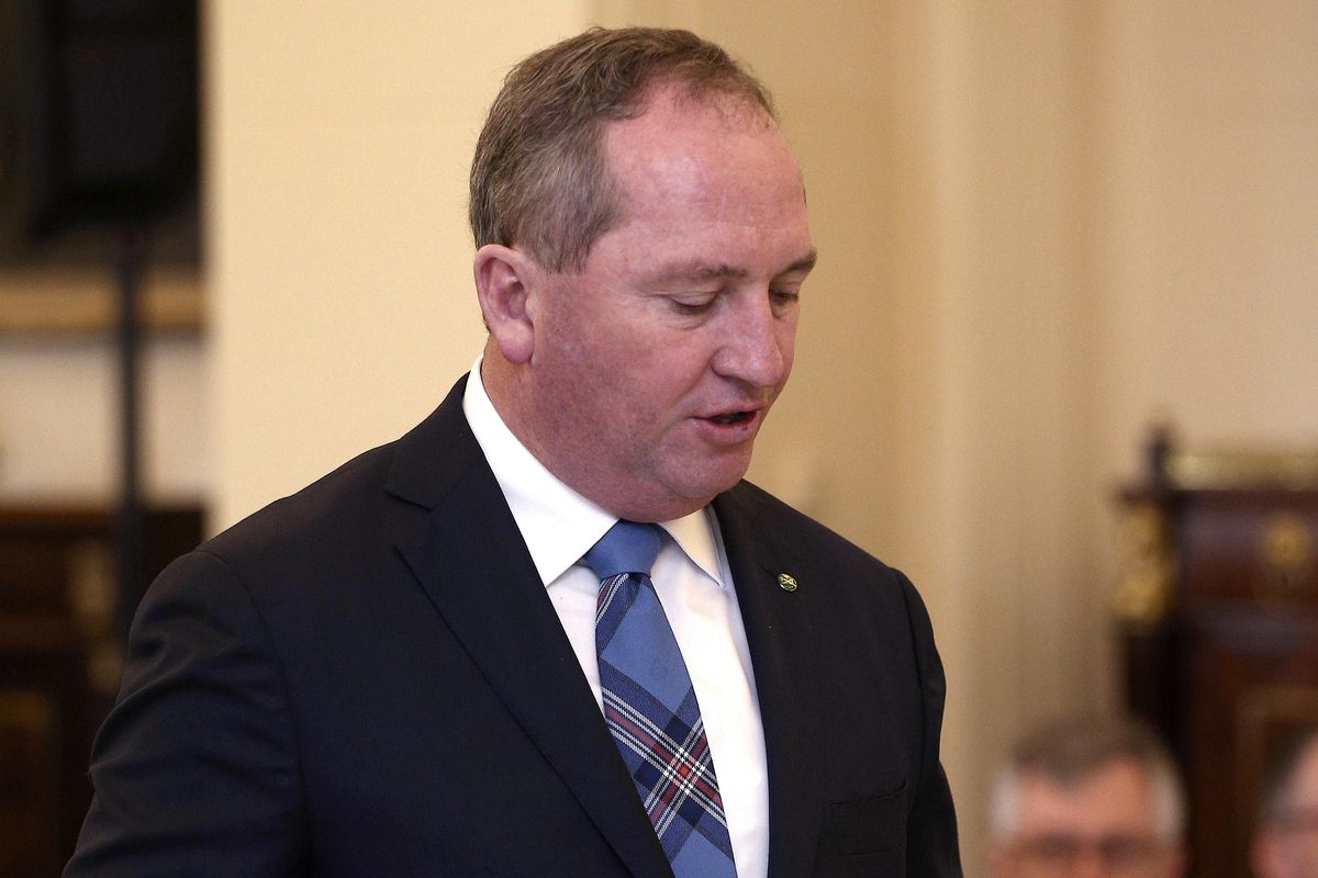 In this July 19, 2016, file photo, Australia’s Deputy Prime Minister Barnaby Joyce takes the oath of office as he is sworn in at Government House in Canberra, Australia. Australia’s High Court disqualified the deputy prime minister and four senators Friday, Oct. 27, 2017, from sitting in Parliament in a ruling that could cost the government its slender majority in Parliament. (Rob Griffith / AP)
