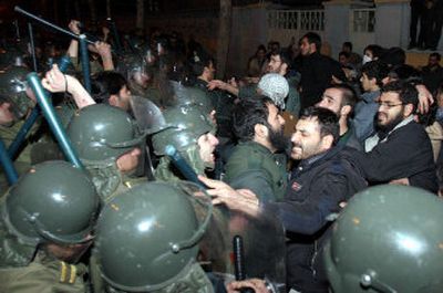 
Iranian police officers scuffle with protesters outside the French Embassy in Tehran on Friday. 
 (Associated Press / The Spokesman-Review)