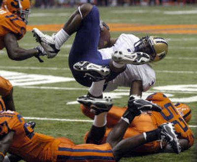 
UW's Marcel Reece is upended by Syracuse's Nick Chestnut. Associated Press
 (Associated Press / The Spokesman-Review)