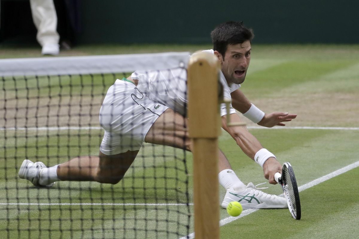 Serbia’s Novak Djokovic returns the ball to Rafael Nadal of Spain during their men’s singles semifinals match at the Wimbledon Tennis Championships, in London, Saturday July 14, 2018. (Ben Curtis / Associated Press)