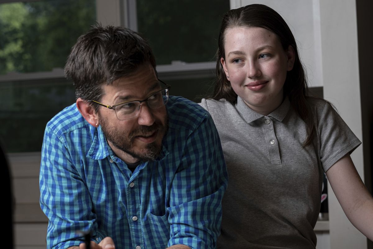 Jay Wamsted, left, and his daughter, Kira, are photographed on Thursday, May 20, 2021 in Smyrna, Ga. Wamsted, who is an 8th grade math teacher, allowed his daughter to skip testing this year. With new flexibility from the Biden administration, states are adopting a patchwork of testing plans that aim to curb the stress of exams while still capturing some data on student learning.  (Ben Gray)
