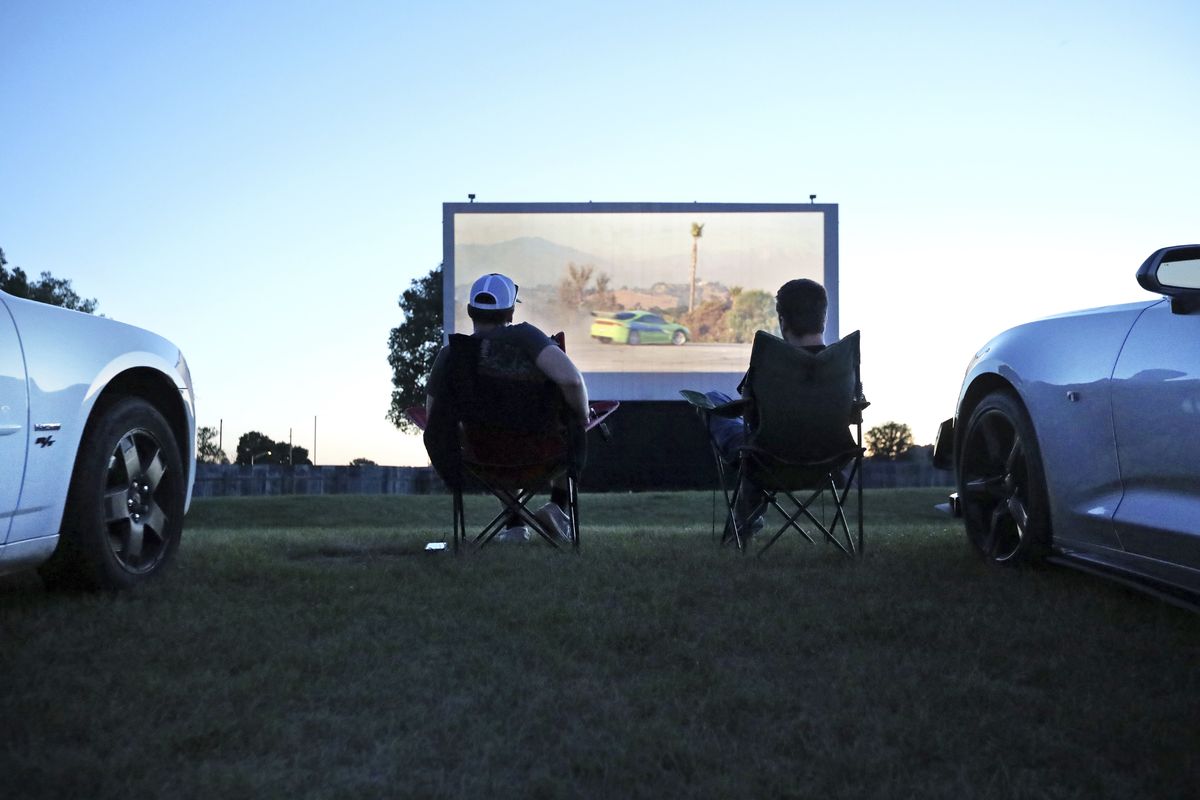 Jeremy Bristol of Basswood and Alex Buroker of Gillingham watch “Fast & Furious” at Starlite 14 drive-in theater in Richland Center, Wisconsin, on July 10.  (Amber Arnold/Associated Press)