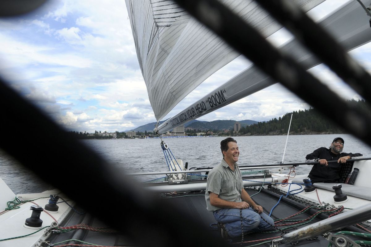 Miles Moore, left and Scott Bailey sail Lake Coeur d’Alene on  Sept. 8. Bailey, of Spokane, had his legs amputated about 10 years ago due to osteomyelitis,  following a 1990 car accident that left him paraplegic. Moore, owner of Hayden-based Sail Marine, and Bailey were cruising the lake as part of a recreational therapy sailing class offered by Moore.  (Kathy Plonka)