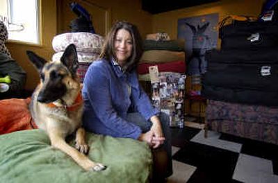 
Deborah Olmsted and her dog Molly sit in the entryway display of dog beds in the Urban Canine at 3103 South Grand Boulevard. 
 (Liz Kishimoto / The Spokesman-Review)