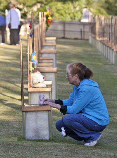 
Sandra Combs pauses at the chair dedicated to bombing victim Baylee Almon in the Field of Chairs at the Oklahoma City National Memorial and Museum on Saturday  in Oklahoma City. Associated Press
 (Associated Press / The Spokesman-Review)