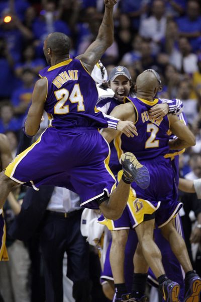 Kobe Bryant and his Lakers teammates celebrate beating the Magic in Game 5 for the franchise’s 15th NBA championship. Bryant scored 30 points in the clinching victory. (Associated Press / The Spokesman-Review)