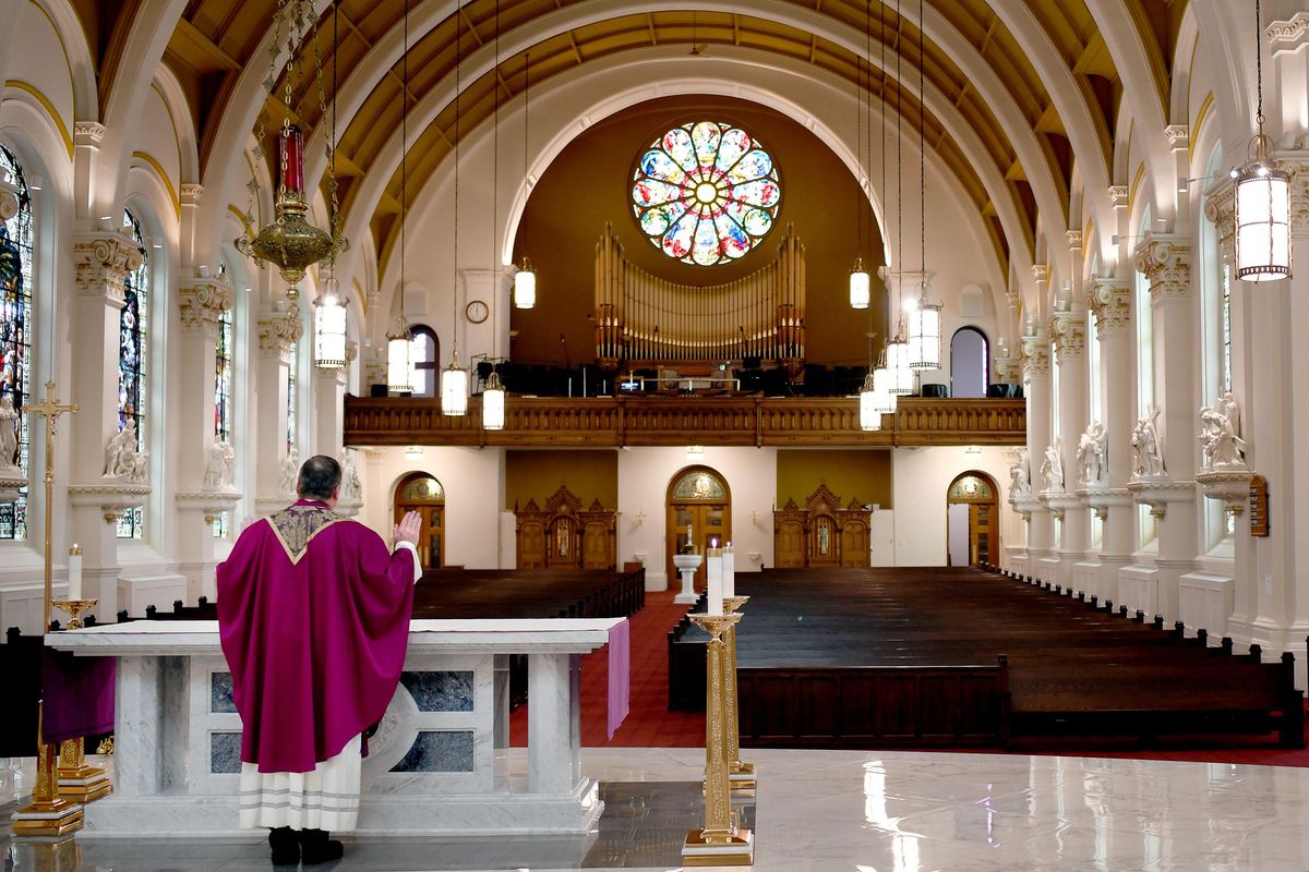 Father Connall conducts mass without a congregation at the Cathedral of Our Lady of Lourdes due to the coronavirus restrictions in Spokane on Friday, March 27, 2020. The mass is available through live streaming. (Kathy Plonka / The Spokesman-Review)