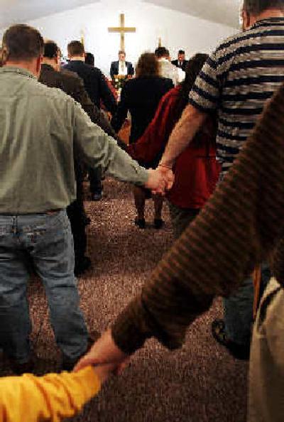 
Family and friends of Jerry Lee Groves, 56, pray during funeral services Sunday in Cleveland, W.Va. 
 (Associated Press / The Spokesman-Review)