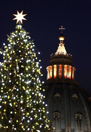 The St. Peter's Basilica is framed by the 30 meters (98 feet) Christmas tree that was lit for the first time at the Vatican, Friday  Dec. 16, 2011. The tree was supplied by Ukraine. (Gregorio Borgia / Associated Press)