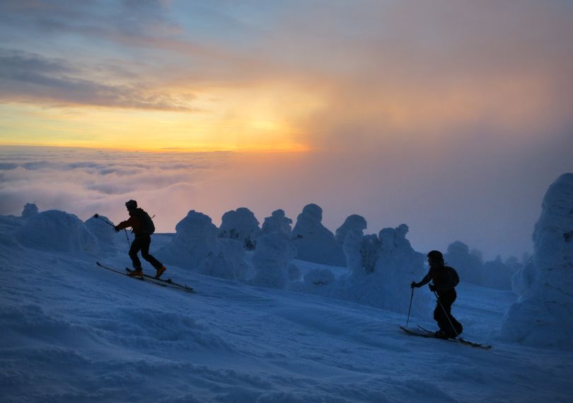 Jeff Zickler and Daniel Henry ascend to the summit of Mount Spokane for a pre-dawn workout, before resort lifts open, followed by a fast ski and splitboard descent. (Travis Nichols)