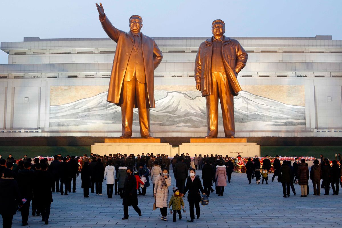 Citizens visit the bronze statues of their late leaders Kim Il Sung, left, and Kim Jong Il on Mansu Hill in Pyongyang, North Korea Thursday, Dec. 16, 2021, on the occasion of 10th anniversary of demise of Kim Jong Il. (Cha Song Ho)