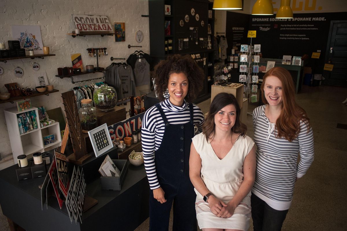 Ginger Ewing, left, co-founder and executive director of Terrain, Jackie Caro and Erin Colladay of Pop Up Shop in Steam Plant Square are preparing for the artisan shop’s move to River Park Square later this month. They are shown at the store on on Wednesday, May 1, 2019. (Kathy Plonka / The Spokesman-Review)