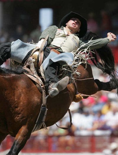 
Rowdy Buechner rides toward a victory aboard Sheep Tick in the bareback competition at last month's Frontier Days Rodeo in Cheyenne, Wyo. 
 (Michael Smith/The Wyoming Tribune-Eagle / The Spokesman-Review)