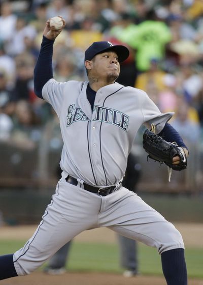 Mariners starting pitcher Felix Hernandez struck out nine A’s over eight innings to pick up win on Saturday. (Associated Press)