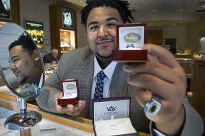 
At 6-foot-3 and 340 pounds, lineman Rico Ocha is hard to miss with his af2 championship ring at his second job selling jewelry at the Spokane Valley Mall.
 (Christopher Anderson / The Spokesman-Review)
