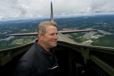 After lifting off from Boeing Field in Seattle, Roger Stadtmueller takes in the scenery from the top of a B-17 called Nine-O-Nine  as it heads for Spokane. The plane developed engine trouble and landed  at Paine Field in Everett for a new cylinder. 
 (Photos by Colin Mulvany / The Spokesman-Review)