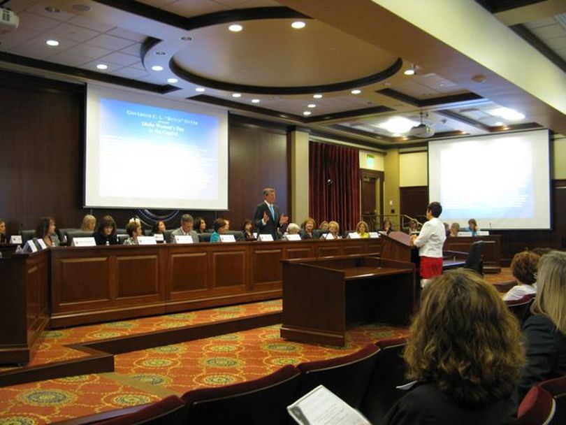 Gov. Butch Otter, flanked by 32 female officials from his administration along with First Lady Lori Otter and Lt. Gov. Brad Little, answers a question about education at his 