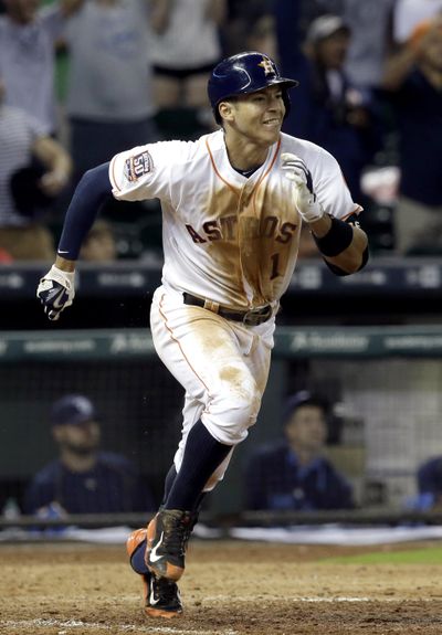 Astros' Carlos Correa runs to first base after game- winning hit in 13th inning. (Associated Press)