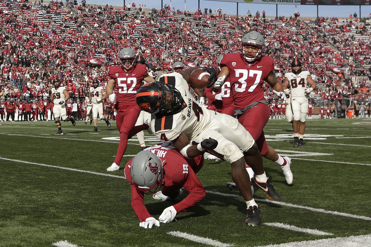 Washington State defensive back George Hicks III (18) tackles Oregon State running back B.J. Baylor (4) during the second half of a Pac-12 game Saturday, Oct. 9 in Pullman, Wash.  (Associated Press)