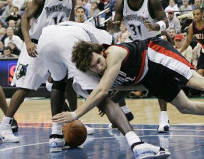 The Minnesota Timberwolves' Kevin Garnett is fouled by Portland's Dan Dickau, right, as they go after a loose ball.
 (Associated Press / The Spokesman-Review)