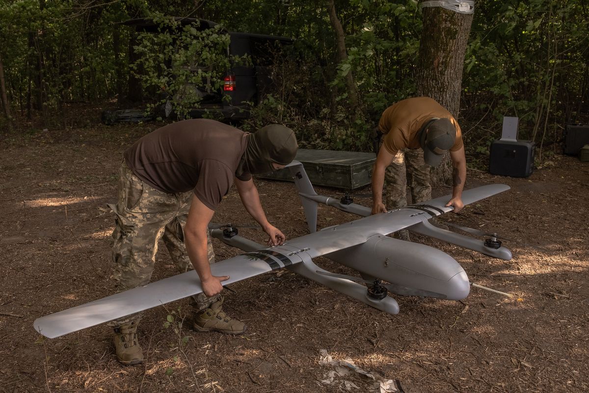 Ukrainian military drone operators of the 22nd Mechanized Brigade assemble a Poseidon reconnaissance unmanned aerial vehicle on their position, in the Sumy region, near the border with Russia, on Aug. 11, 2024, amid the Russian invasion of Ukraine.   (Roman Pilipey/AFP/GETTY IMAGES NORTH AMERICA/TNS)