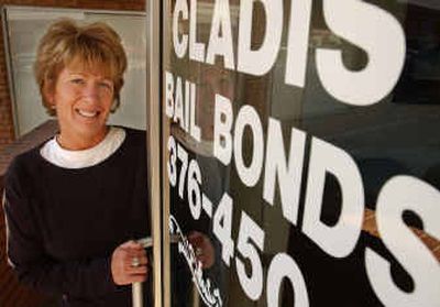 
Kathy Cladis stands next to the door to her bail bonds business in Boise on Friday. Cladis' job is to chase down people who fail to show up in court.
 (Associated Press / The Spokesman-Review)