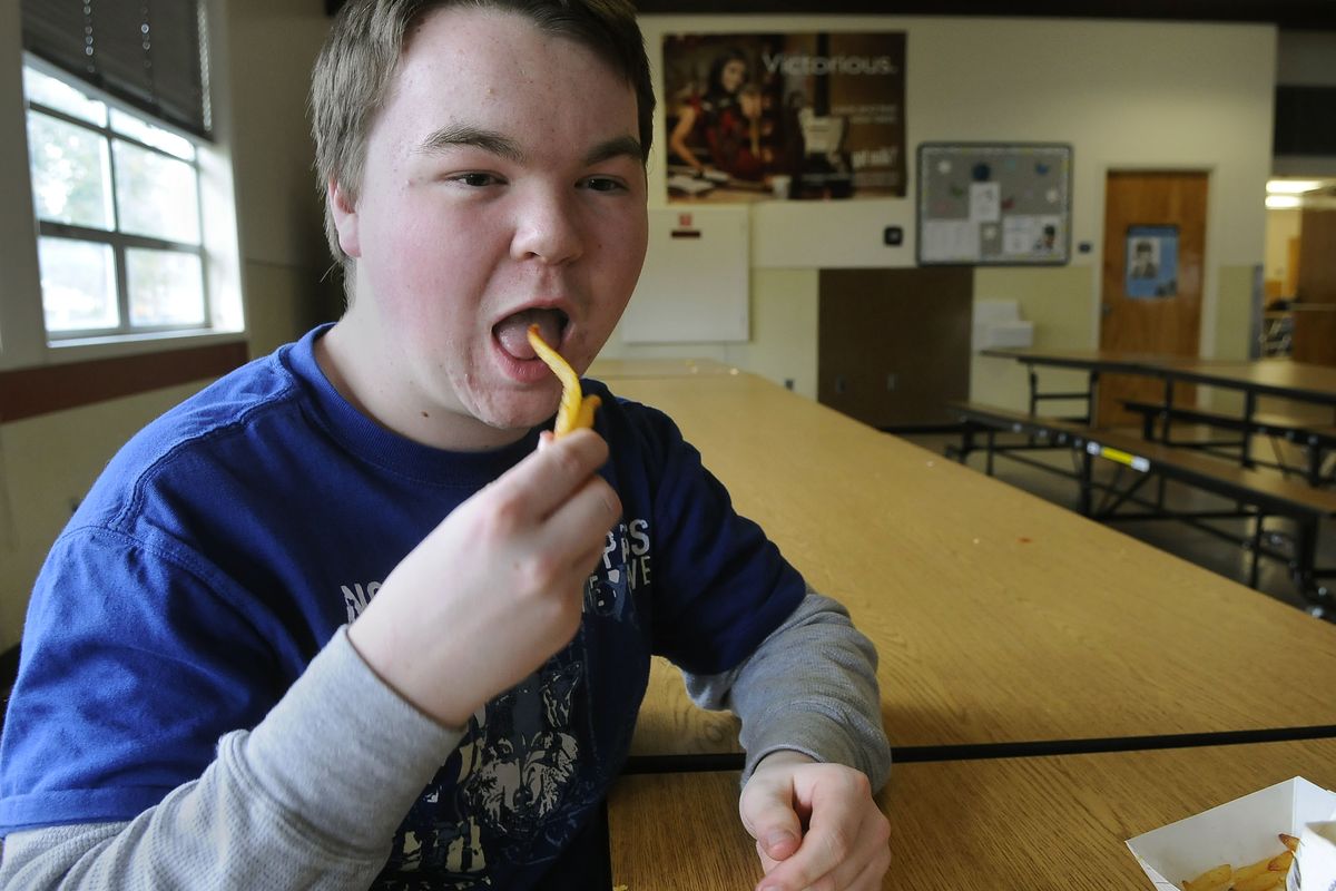 Sacajawea Middle School eighth-grader Scott Wolfe, 14, munches on french fries at the end of his lunch period on Wednesday. (Dan Pelle)