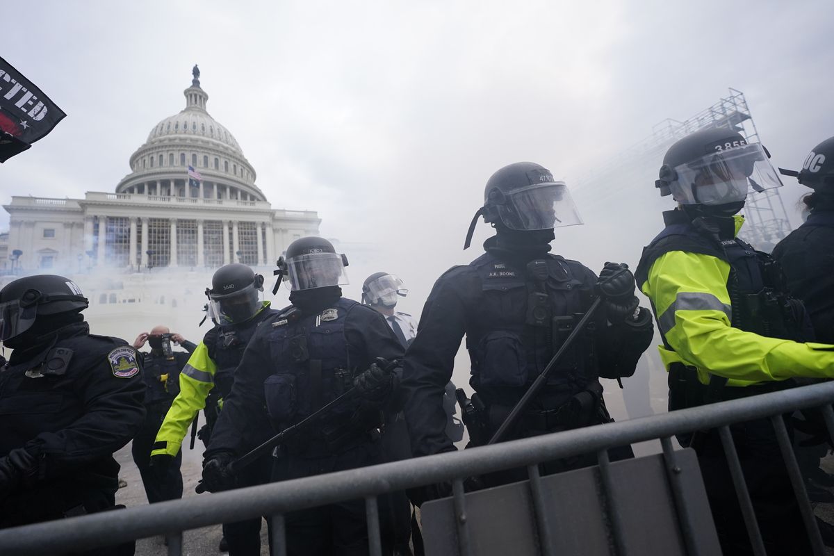 FILE - In this Jan. 6, 2021, file photo, police stand guard after holding off rioters who tried to break through a police barrier at the Capitol in Washington. Hundreds of emails, texts, photos and documents obtained by the Associated Press show how a patchwork of law enforcement agencies from all directions tried to give support as protesters poured into town. But a lack of coordination and adequate planning left the Capitol vulnerable, and resulted in a deadly_and potentially avoidable_breach.  (Julio Cortez)