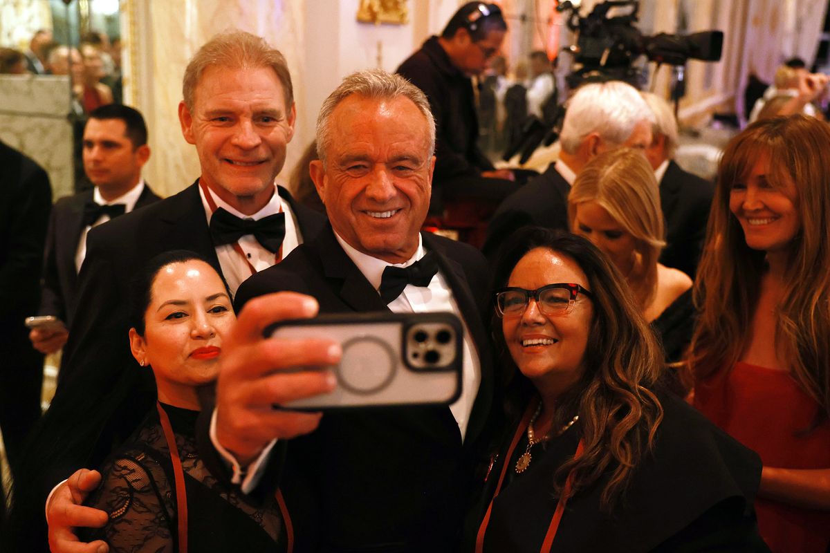 Above: Robert F. Kennedy Jr. takes a selfie with guests at the America First Policy Institute Gala held at Mar-a-Lago on Thursday in Palm Beach, Fla. President-elect Donald Trump has been announcing a number of nominees for his upcoming administration, including Kennedy, who has been tapped as Health and Human Services secretary, according to published reports. Left: U.S. House Speaker Mike Johnson (R-La.), center, gestures as he listens to Trump speak during the America First Policy Institute Gala.  (Joe Raedle)