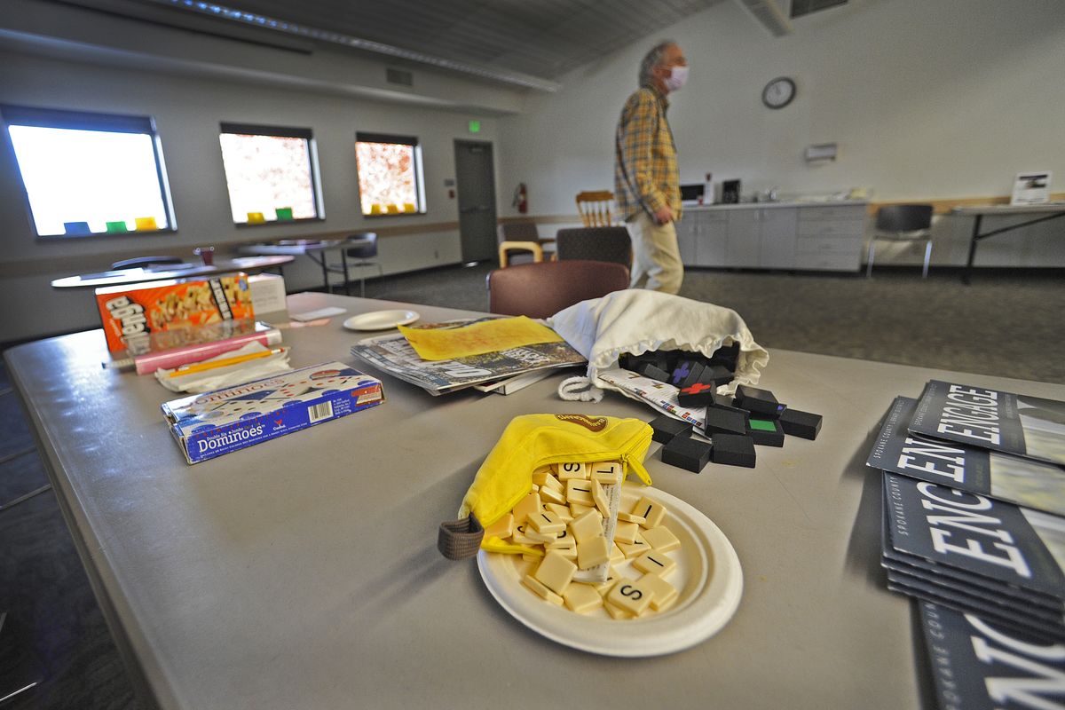 Don Nelson of the Spokane County Library District sets out crafts and games Tuesday at the North Spokane Library on Hawthorne Road.  (Christopher Anderson/For The Spo)