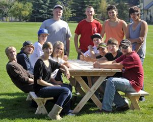 A team of students gather around a picnic table and bench they built during their East Valley High School construction class on Friday in Spokane Valley. (Dan Pelle)