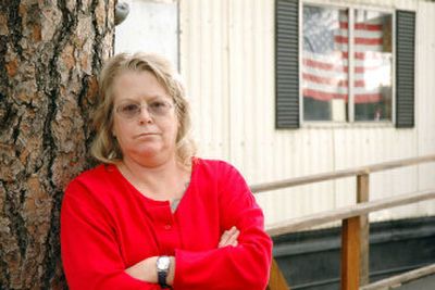 
Beverly DuBois, a convicted felon, stands outside of her trailer home near Chattaroy, Wash., on Thursday. DuBois has been denied voting rights since her release from jail three years ago. 
 (Associated Press / The Spokesman-Review)