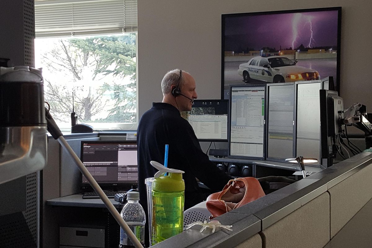 A Spokane County emergency dispatcher takes a call on Wednesday, April 7, 2017. (Chad Sokol / The Spokesman-Review)