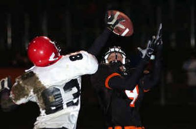 
Moscow's Shon Helbling (83) gets a hand on a pass intended for Post Falls wide receiver Zack Deines (4) to deny a touchdown, Friday night at Post Falls, but the Trojans scored on the next play. 
 (Tom Davenport/ / The Spokesman-Review)