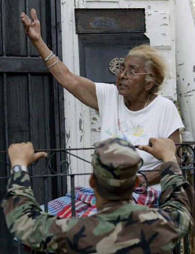 
Margarita Hernandez tells a Texas National Guardsman on Tuesday that she can take care of herself and won't leave her house in New Orleans. 
 (AFP/Getty Images / The Spokesman-Review)