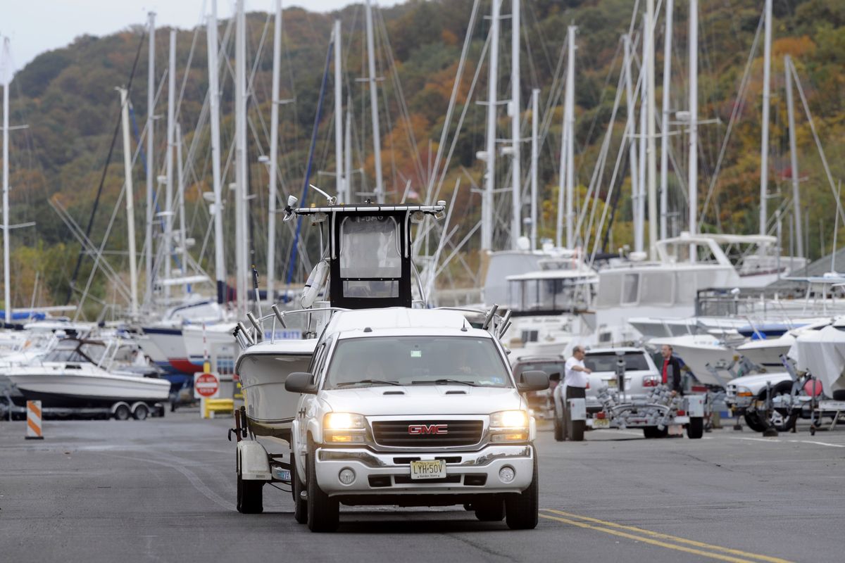 As Hurricane Sandy moves up the East Coast, owners remove their boats from the water at the Atlantic Highlands Marina, Friday Oct. 26, 2012 in Atlantic Highlands, N.J. When Hurricane Sandy becomes a hybrid weather monster some call "Frankenstorm" it will smack the East Coast harder and wider than last year