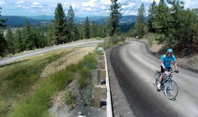 
Evan Reich works his way up Strong Road from Indian Trail Road to the Five Mile Prairie on Wednesday. The winding gravel road may be better suited for his mountain bike than the cars that use it as a shortcut to the north side of town. Strong Road will be studied as part of Spokane's six-year street plan.
 (Christopher Anderson/ / The Spokesman-Review)