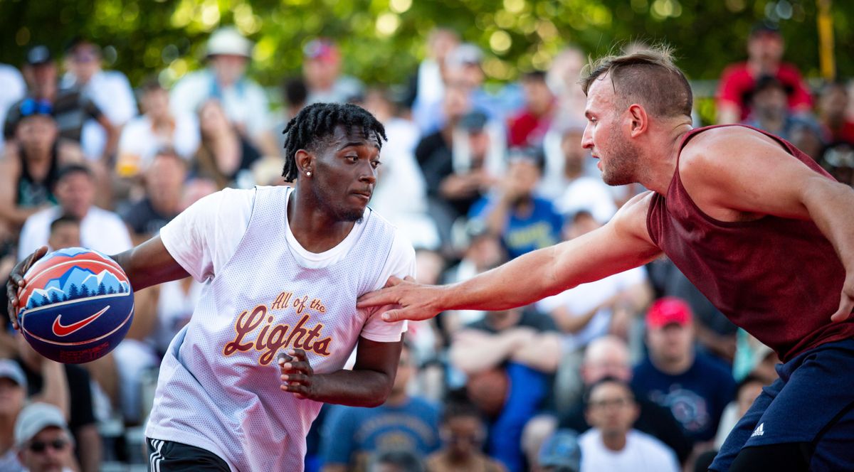 Warren Edmonson of All of the Lights (left) dribbles forward against Cam Dodd of Canada during the men