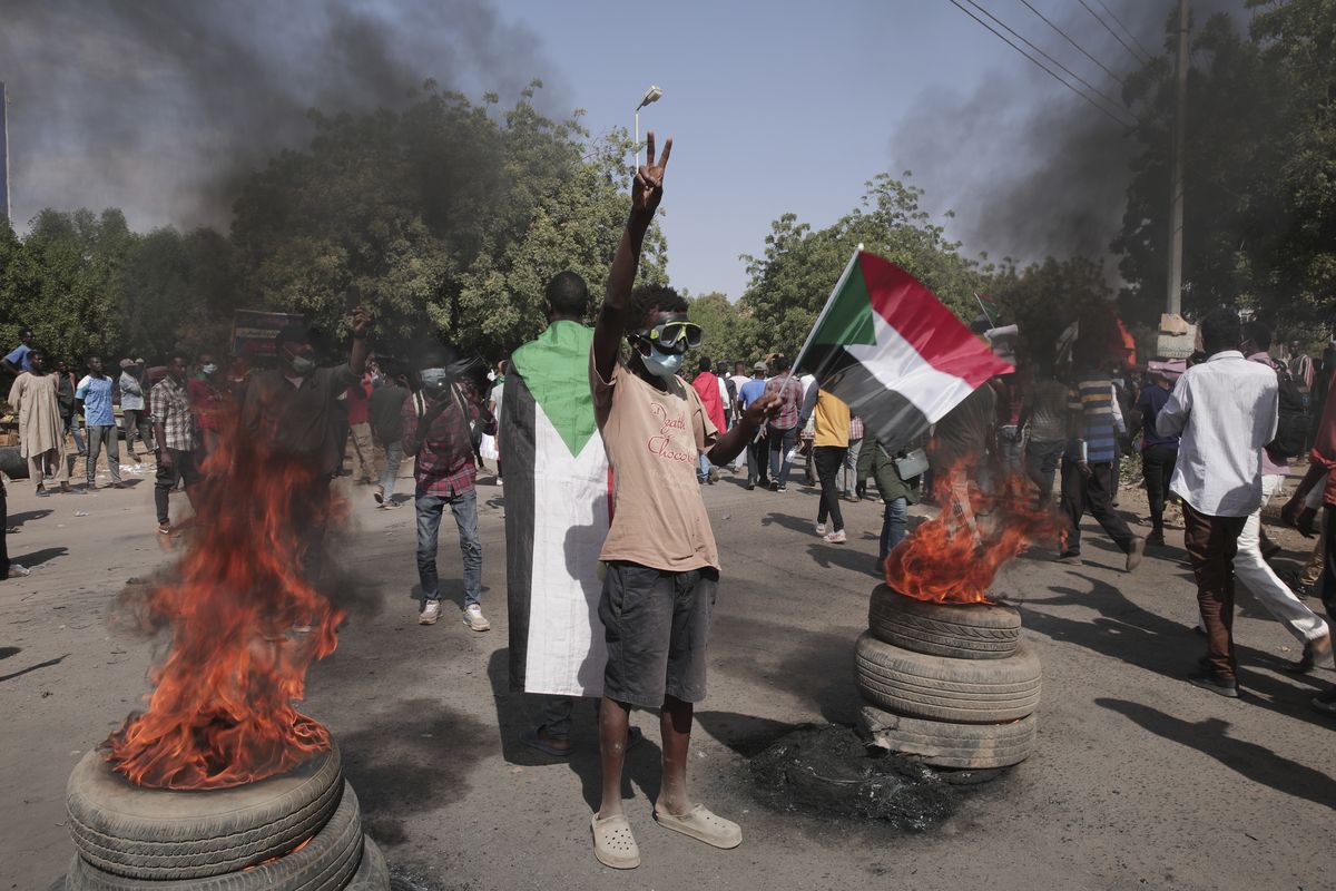People take part in a protest against the October military takeover and a subsequent deal that reinstated Prime Minister Abdalla Hamdok but sidelined the movement in Khartoum, Sudan, Sunday, Dec. 19, 2021. (Marwan Ali)