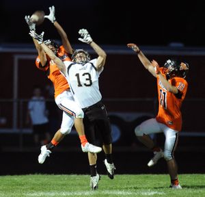 Post Falls' (2) Braden Davenport breaks up a pass intended for Capital receiver Ian Kinkead (13) during a high school football game on Friday, August 30, 2013, at Post Falls High School in Post Falls, Idaho. Capital led 14-0 at the half. (Tyler Tjomsland / The Spokesman-Review)