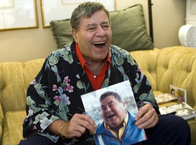 
Comedian Jerry Lewis, holding up a photo of himself bloated from drugs he was taking to overcome chronic pain, chronicles the relationship between himself and partner Dean Martin in his new book, 