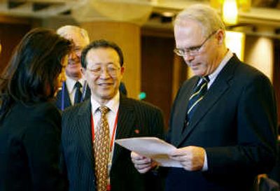 
U.S. envoy Christopher Hill reads documents handed to him by his North Korean counterpart Kim Kye Gwan on Sept. 27. Associated Press
 (Associated Press / The Spokesman-Review)