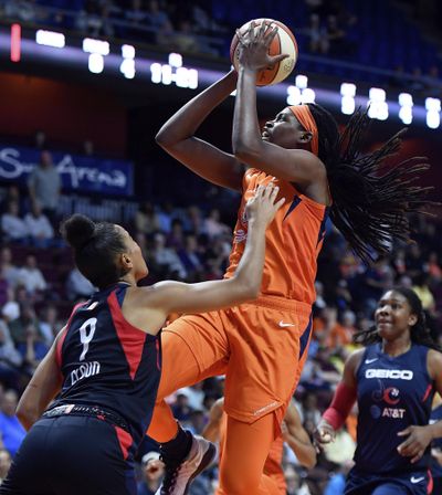 In this June 11, 2019 photo, Connecticut Sun center Jonquel Jones shoots over Washington Mystics guard Natasha Cloud during a WNBA basketball game in Uncasville, Conn. Connecticut has risen back to the top of the standings behind solid play from Jonquel Jones and Alyssa Thomas. (Sean D. Elliot / Day via AP)