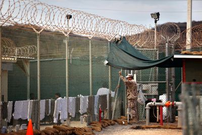 A guard talks to a Guantanamo detainee in the open yard in Camp 4 detention center on the U.S. Naval Base in Guantanamo Bay, Cuba, in January.  (File Associated Press / The Spokesman-Review)