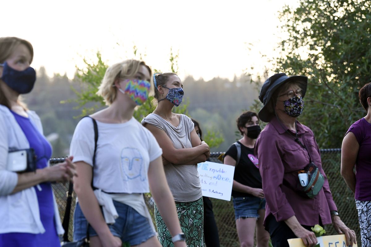Protesters gather during a Silent Suffrage March on Tuesday, Aug. 18, 2020, at Polly Judd Park. in Spokane, Wash. The march was held to honor the 100th anniversary of women winning the vote by the ratification of the 19th amendment.  (Tyler Tjomsland/THE SPOKESMAN-REVIEW)