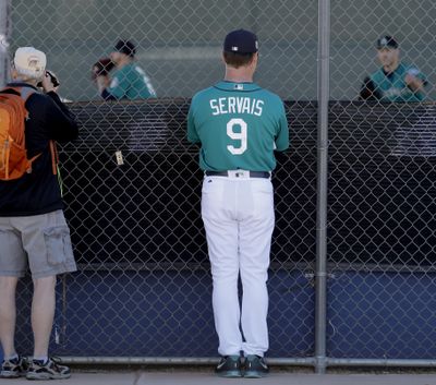 Mariners manager Scott Servais watches workouts last Wednesday. (Charlie Riedel / Associated Press)