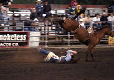 J.P. Sample hits the dirt during his first bareback ride Friday night at the Cheney Rodeo.
(Christopher Anderson/ / The Spokesman-Review)