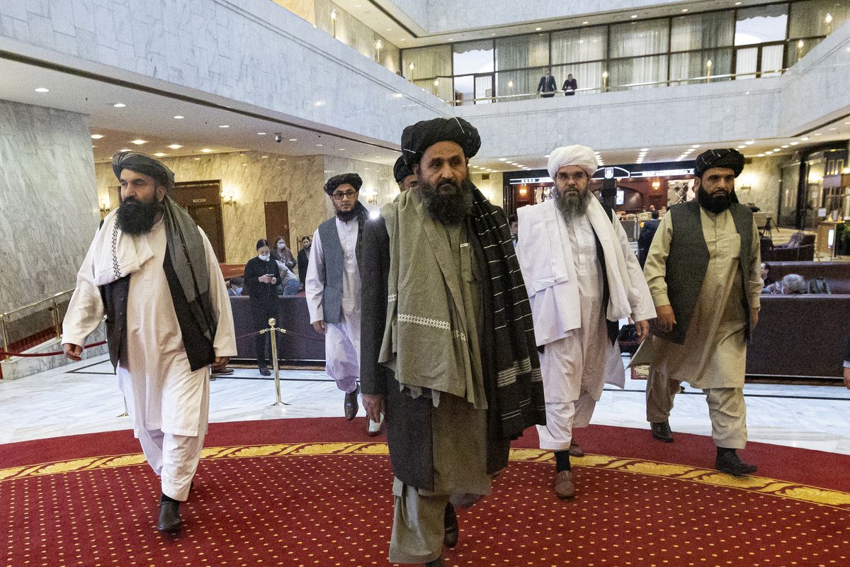 Taliban co-founder Mullah Abdul Ghani Baradar, center, arrives with other members of the Taliban delegation for an international peace conference in Moscow, Russia, Thursday, March 18, 2021. Russia is hosting a peace conference for Afghanistan, bringing together government representatives and their Taliban adversaries along with regional observers in a bid to help jump-start the country