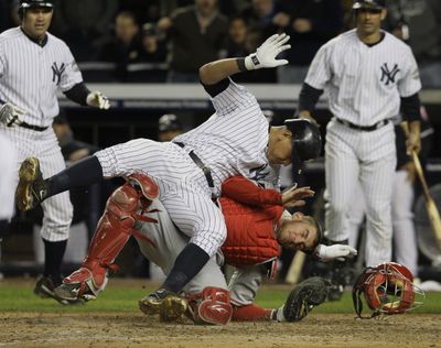 Alex Rodriguez of the Yankees collides with Angels catcher Jeff Mathis as he tries to score on a double by Hideki Matsui during the fifth inning.   (Associated Press / The Spokesman-Review)