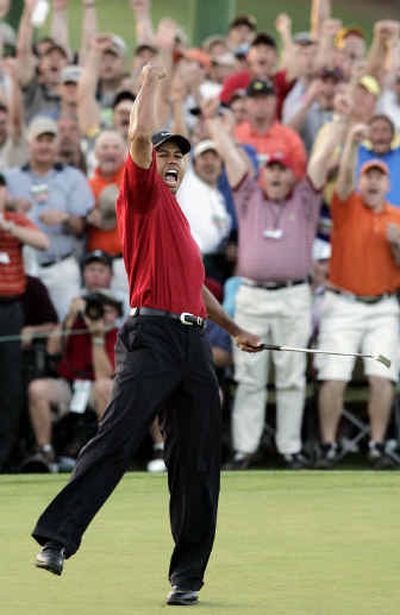 
Tiger Woods reacts to winning the 2005 Masters in a playoff with Chris DiMarco on the 18th hole Sunday.
 (Associated Press / The Spokesman-Review)